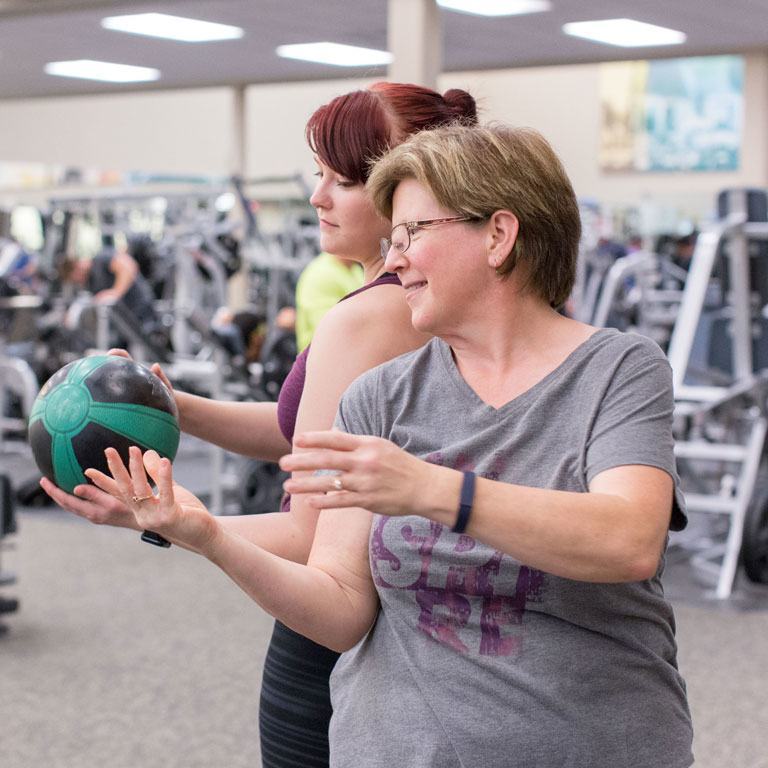 Bernetta and daughter exercising with medicine ball
