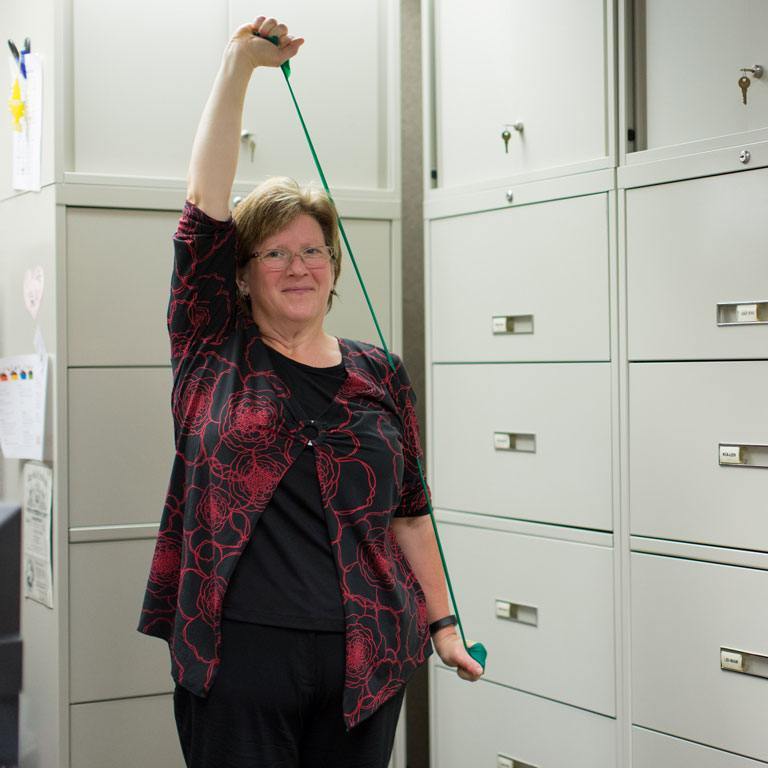 Bernetta stretching in office