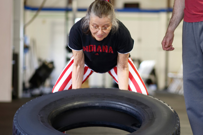 Linda lifting a tire