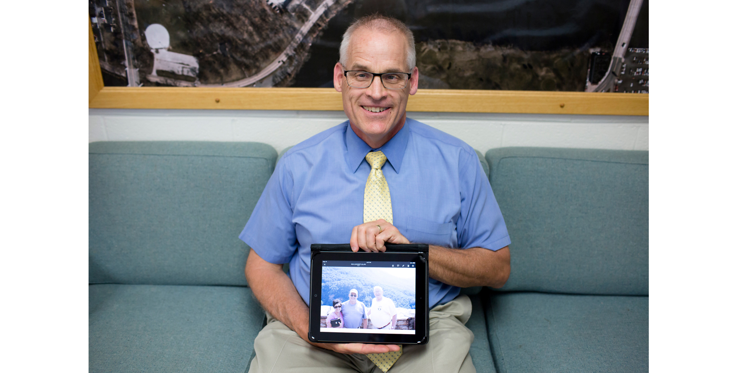 Michael Prater with a photo of family